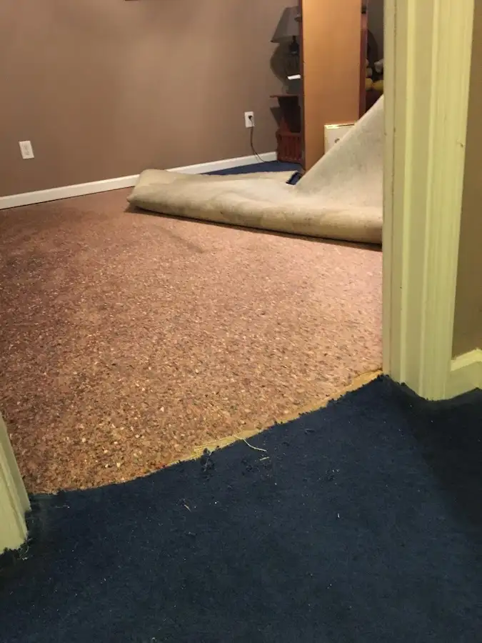 Carpet pad removal revealing water damage during Drying & Dehumidification in Boiling Spring Lakes